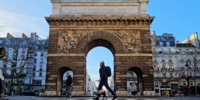 Best things to do in Paris France - Jay Swanson - walking across the Porte de Saint-Martin